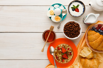 Rich breakfast menu on wooden table, copy space