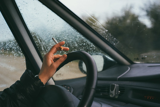 woman smoking in the car