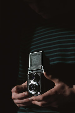 Man using an old twin lens reflex camera