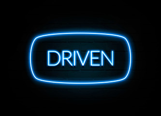 Driven  - colorful Neon Sign on brickwall