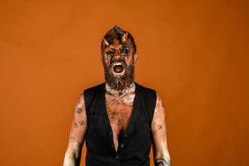Halloween man satan shout with anger on orange background