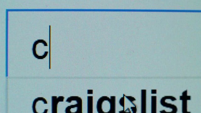 Person typing in browser search bar, looking for car rental, carpooling service
