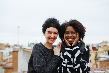 Two smiling female friends looking at camera