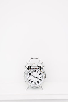 chrome retro clock on mantelpiece