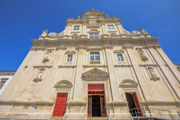 Fototapeta na wymiar The main facade of the New Cathedral of Coimbra, Se Nova de Coimbra, is a Catholic church of Coimbra in Baroque style. Coimbra is one of the oldest university cities in Europe. Central Portugal.