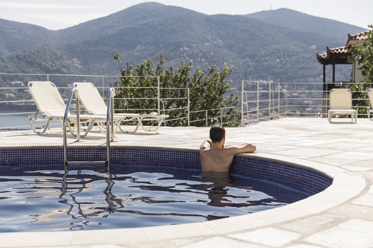 Man relaxing in the hotel pool