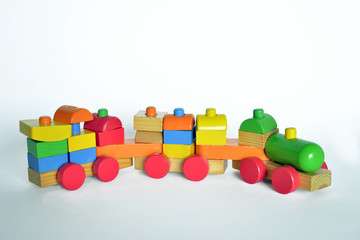 wooden train with locomotive and wagons,   assembled with colored blocks, isolated   on white background. part of a series