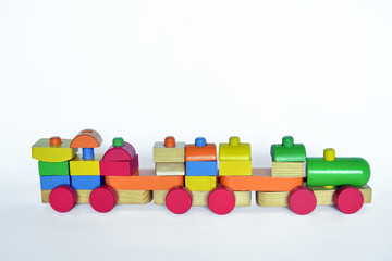 wooden train with locomotive and wagons,   assembled with colored blocks, isolated   on white background. part of a series