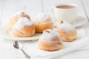 a dish of choux cream with a cup of tea or coffee for an afternoon break.