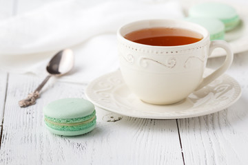 Cup of tea and Macaroons on vintage pastel background