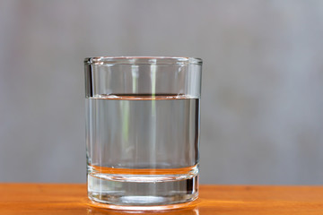 Drinking water in a glass on a wooden table