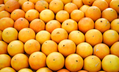 Oranges in stack in a vegetables stand in a street market in Madrid, Spain.