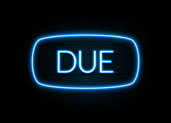 Due  - colorful Neon Sign on brickwall