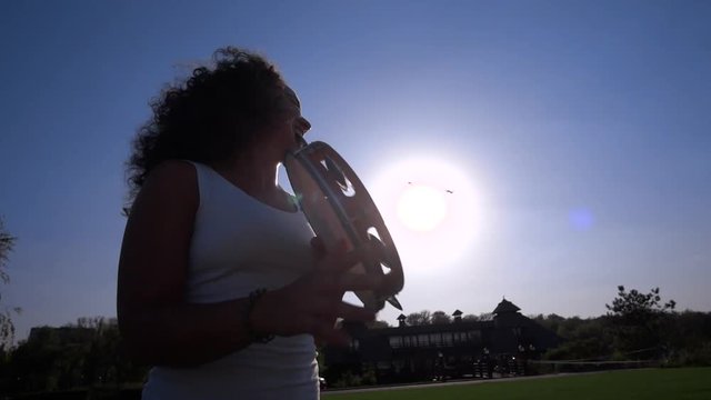 Young woman playing the tambourine