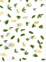 Pattern of citrus fruits. Slices of lemon, lime and mint on a white background. Top view, flat lay.