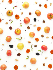 Pattern of red apples, prunes and dried dried apricots. The concept of a healthy diet. Composition of fruits on a white background. Top view, flat lay.
