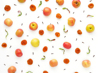 Pattern of red apples and dried dried apricots. The concept of a healthy diet. Composition of fruits on a white background. Top view, flat lay.