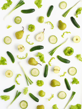 Vegetables and fruits on a white background. Pattern of vegetables and fruits. Composition of cucumber, pepper, lettuce leaves, pear, onion, green radish.Top view, flat lay. Food background collage. 