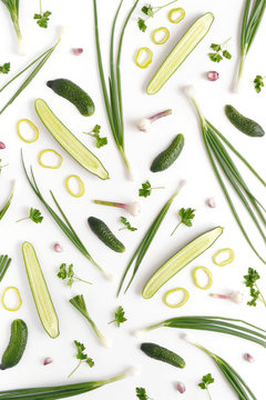 Abstract composition of vegetables. Vegetable pattern.Сucumbers, garlic, tomatoes and green onions on a white background. Food concept.Top view, flat lay. Food background. Food wallpaper.