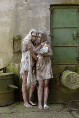 A scene of poverty with two young homeless girls.  They are seen to be situated in a poor unclean...