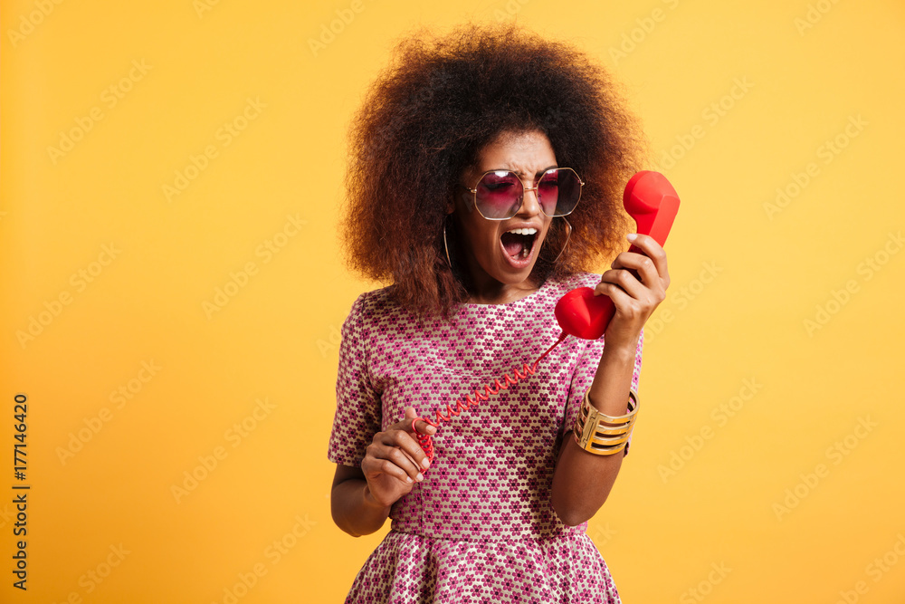 Wall mural Portrait of a crazy angry afro american woman