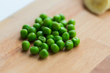 close up of green pea on wooden cutting board