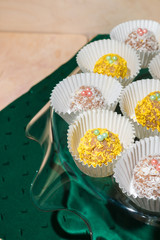 Yellow and white cakes in white cups on a glass stand