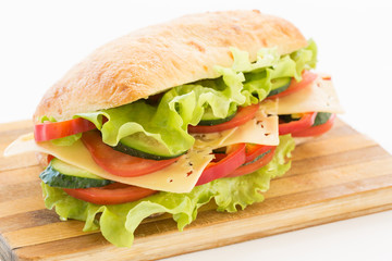 Ciabatta Sandwich with cheese on cutting board
