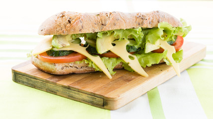 sandwich with avocado and cheese on wooden board
