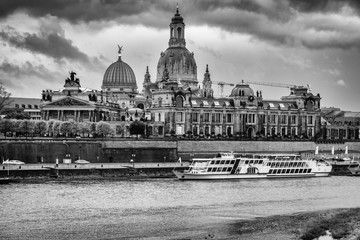 Fototapeta na wymiar View on Dresden from the north shore of the Elbe on a stormy day in October. You can see the long Terrace, Albertinum, University of fine arts and a steam ship