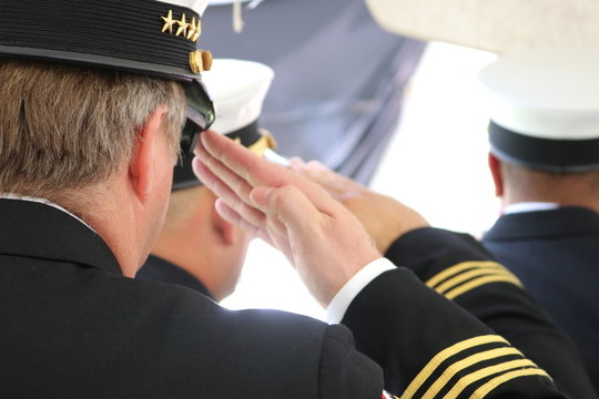 A Military Man Saluting The Flag