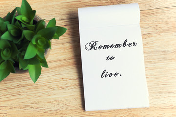 Inspirational quotes with phrase - remember to live. Retro style and faded effect background.