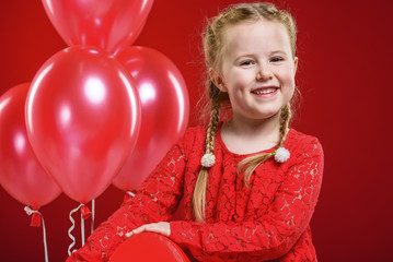 Valentine's Day girl in red dress with a red heart.