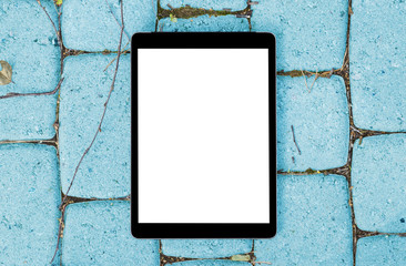 Tablet computer on grey stone blue background. Isolated white screen with copy space. Empty space for text. Empty blank screen.