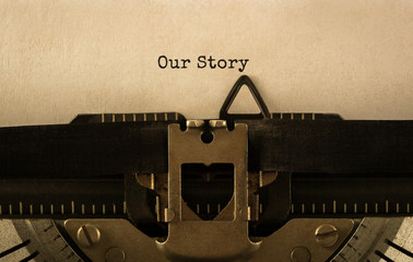 Text Our Story typed on retro typewriter - obrazy, fototapety, plakaty