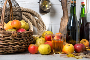 basket of apples, bottles of cider