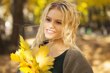 Portrait of a young beautiful woman in gray coat