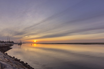 Sunrise seascape view of Olhao Marina, waterfront to Ria Formosa natural park. Algarve.