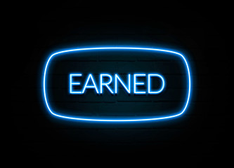 Earned  - colorful Neon Sign on brickwall