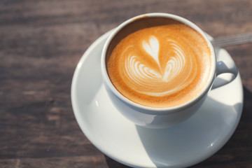 Cup of coffee latte, with heart shape.