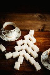 cake decorated Christmas tree branches and berries on a background of the Christmas tree and two cups of coffee