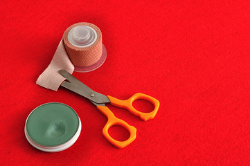 Plaster, scissor and ointment