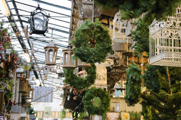 Christmas wreaths, cages and lanterns at bird market in Paris (France).