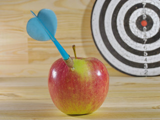 Dart, apple and dartboard. Target darts. Concept for success. Hit in apple