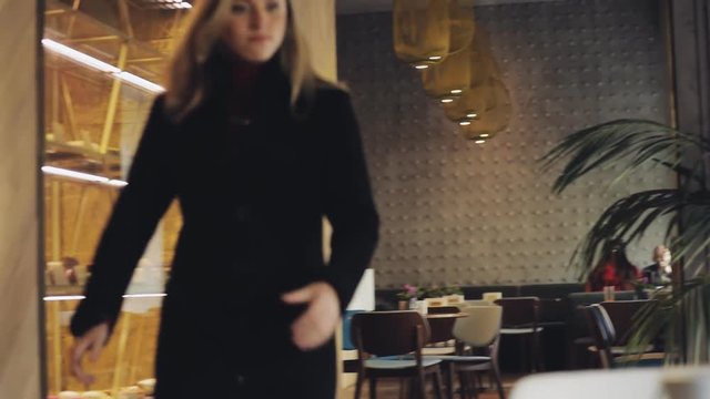 Crazy hungry bulimia woman fast eating cake in cafe