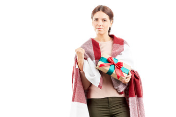 Fototapeta premium Portrait of woman wrapped in blanket holding Christmas gift
