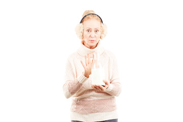 Portrait of senior woman wearing sweater and earmuffs
