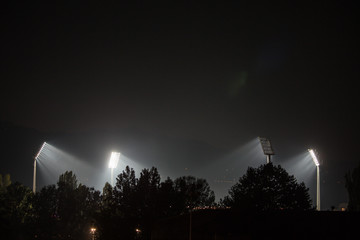 Maintaining a football match, a night game, floodlights on the stadium, the field where the footballers are located