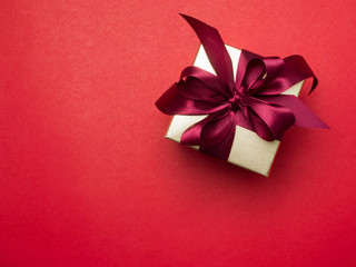 Valentine festival , New year Gold gift box with red ribbon. Red background for create idea copy space.