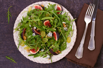 Grapes, figs, blue cheese, arugula and walnuts salad. View from above, top studio shot, horizontal
